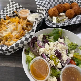 Greek salad, cheese fries, and hush puppies.