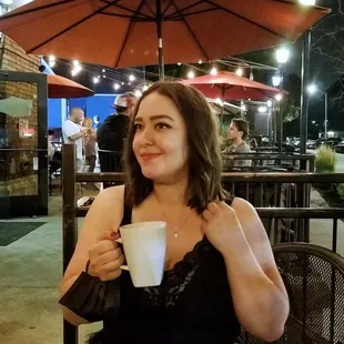 a woman holding a cup of coffee