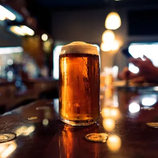 a pint of beer on a bar