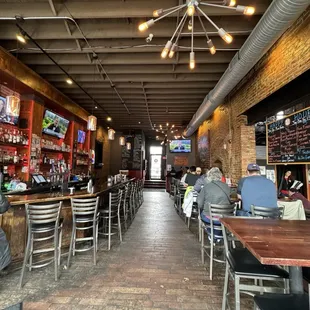 people sitting at tables in a restaurant
