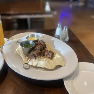 Happy hour filet mignon on flat bread with 2 dipping sauces.