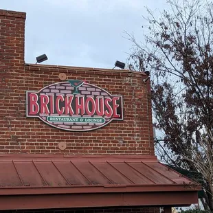 a brick building with a sign that says brick house
