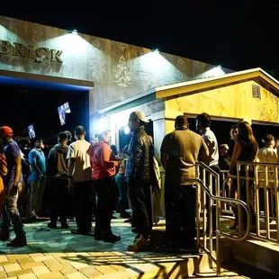 a crowd of people standing outside of a building