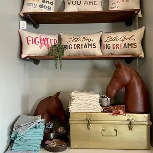shelves with pillows, pillows, and a horse