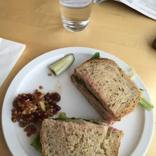 a sandwich and pickle on a plate
