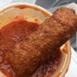 a hand holding a hot dog