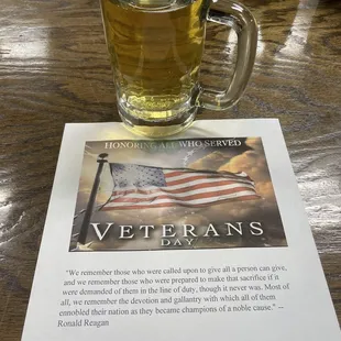 A beer at the bar at an empty stool.