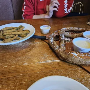 Huge pretzel and fried green beans appetizers.