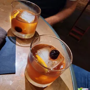 two glasses of drink on a table
