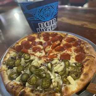 Half pepperoni and half pineapple and jalapeños pizza