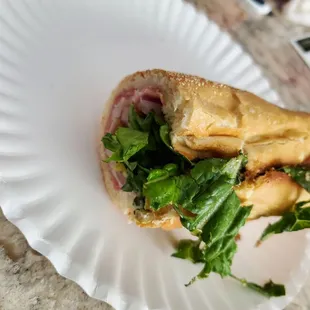 a sandwich on a paper plate