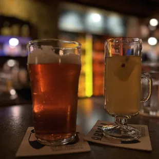 a glass of beer and a mug of tea