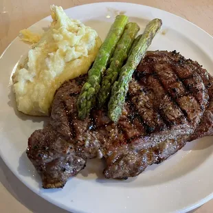 Ribeye with roasted garlic mashed potatoes and asparagus.