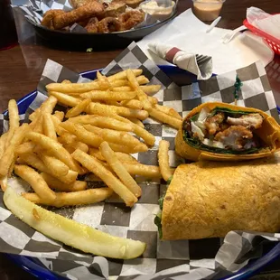 Spinach chicken wrap with garlic fries