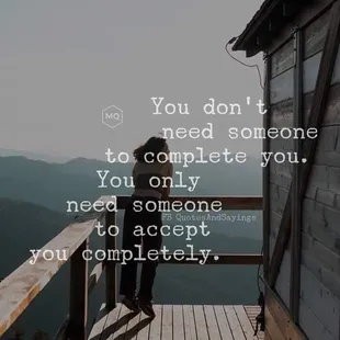 a person standing on a deck overlooking a mountain