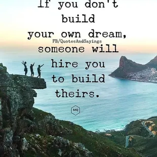 two people standing on a cliff with the ocean in the background