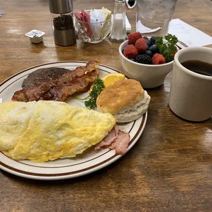 Ham and Swiss omelet, sides of sausage, bacon and fruit.