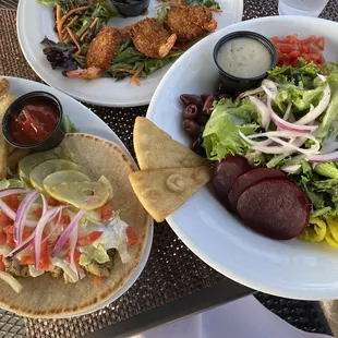 Mediterranean chicken wrap, Greek salad, and coconut shrimp.