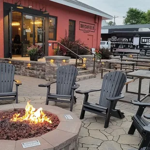 a fire pit with chairs around it