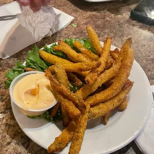 a plate of fries with a side of mustard