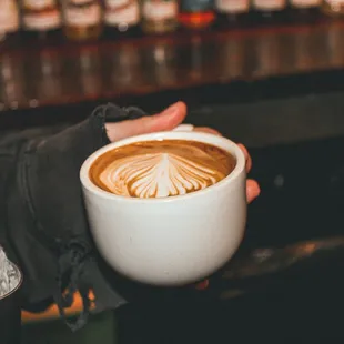 a person holding a cup of coffee