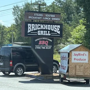 a black van parked in front of a brickhouse bbq