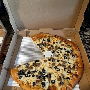 Olive oil and garlic pizza with sausage and black olives delicious