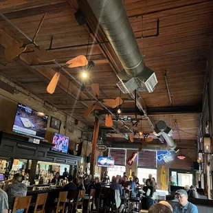 Huge bar area with booths, pub tables, hang out space, and counter seats