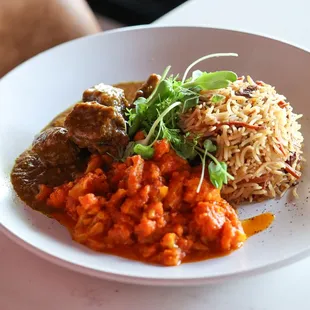 Basmati rice topped with almonds, raisins and carrots, flavored with cardamom, served with beef shoulder cut and sauteed cauliflower