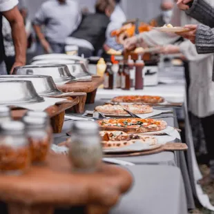 people serving pizza
