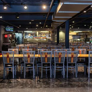 a large dining room with tables and chairs