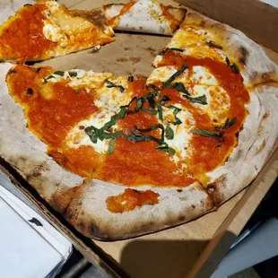 Margherita pizza, sloppy, wet, uncooked center, sauce tastes like tomato soup, barely any basil.
