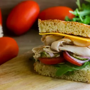 a turkey sandwich with tomatoes and lettuce