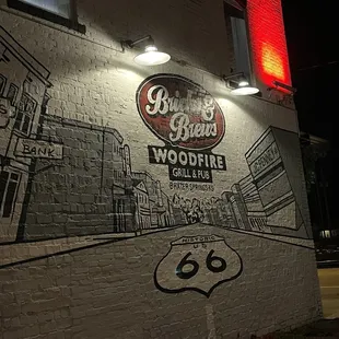 a route 66 sign painted on the side of a building