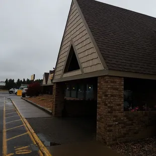 a brick building with a triangular roof