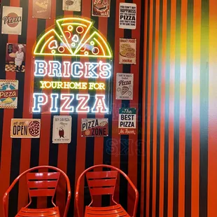 two chairs in front of a neon sign