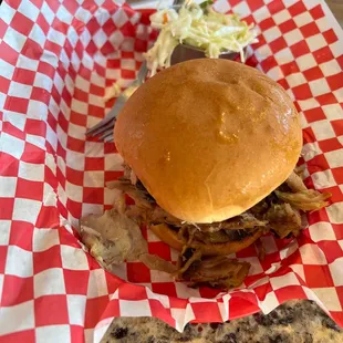 a pulled pork sandwich and coleslaw