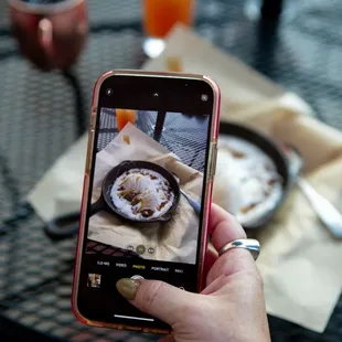 a person taking a picture of food