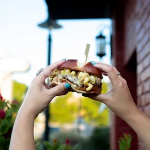 a person holding a sandwich