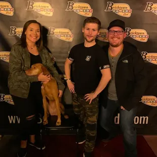 three people and a dog