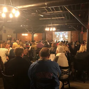 a crowd of people sitting at tables