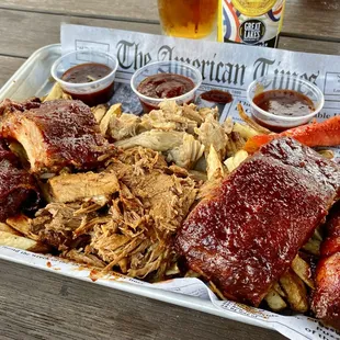 Smoked Board with 4 oz Brisket, 4 oz Smoked Pulled Pork, (2) 2-bone Smoked Ribs, 2 Brisket Poppers - 3 types of BBQ sauces on the side