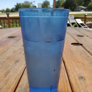 a blue plastic cup on a wooden table