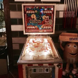 a pinball machine and a teddy bear