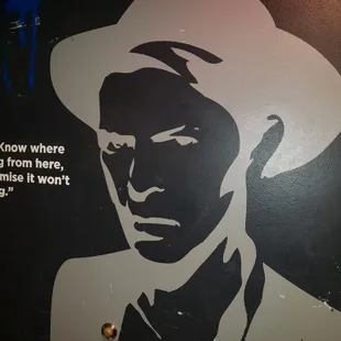 a man with a hat and a quote