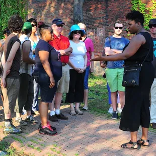 Performer Bria Walker leads participants in Saints Tour, a immersive, mobile experience in Braddock, Pa.
