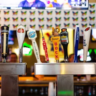 a row of beer taps in a bar