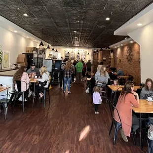 people sitting at tables in a restaurant