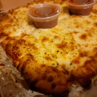 a cheese pizza with sauces