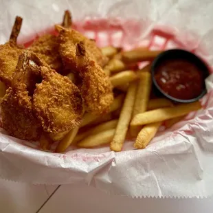 Shrimp and fries served with a side of coleslaw